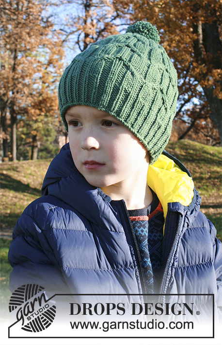 Green Bird / DROPS Extra 0-1358 - Knitted hat for children with cables and pompom in DROPS Merino Extra Fine. Size 2 - 9 years
