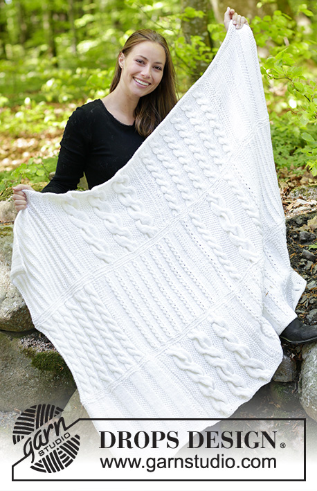 White Sands / DROPS 183-15 - Knitted blanket with squares in texture and cables.
Piece is knitted in DROPS Nepal.