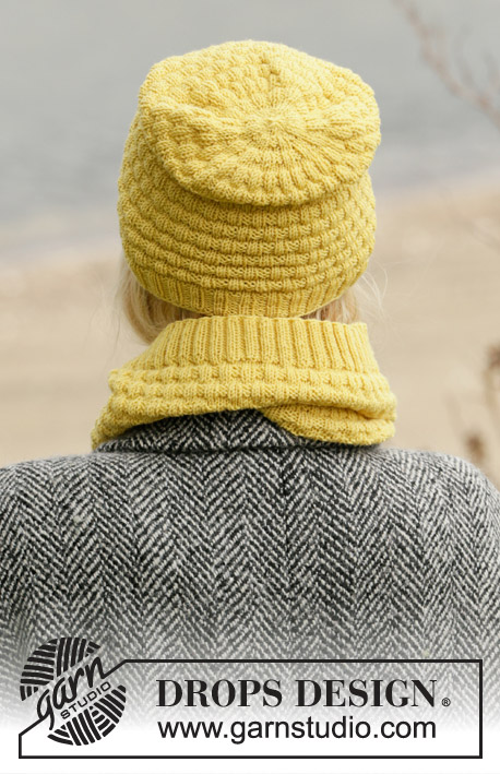 Follow the Sun / DROPS 204-6 - Knitted hat, neck warmer and wrist warmer in DROPS BabyMerino. The piece is worked with texture and ribbed edges.