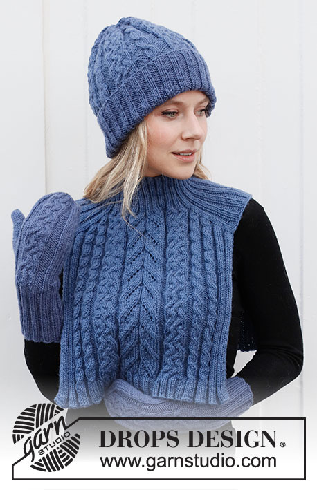 Cool Cables Set / DROPS 214-25 - Knitted hat, neck warmer with saddle shoulder and mittens in DROPS Merino Extra Fine. The whole set is worked with cables and ribbed edging.
