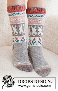 Dancing Bunny Socks / DROPS 229-34 - Knitted socks in DROPS Karisma. The piece is worked top down in stockinette stitch, with multi-colored pattern and heart, Easter bunny and flower. Sizes 35 – 46 = US 4 1/2 - 12 1/2. Theme: Easter.