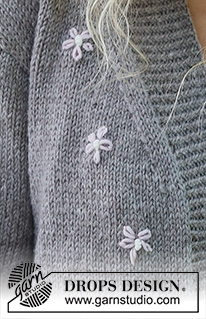 Shy Daisy Cardigan / DROPS 231-33 - Alhaalta ylös neulottu jakku DROPS Merino Extra Fine -langasta. Työssä on sileää neuletta ja kirjottuja kukkia. Koot S-XXXL.