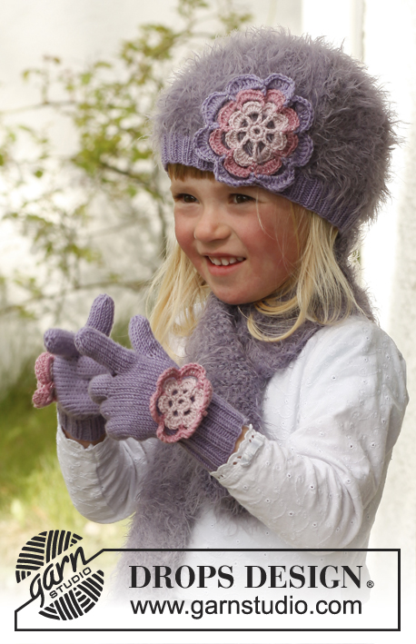 Michelle gloves / DROPS Children 23-13 - Lapsen neulotut käsineet DROPS BabyMerino- ja DROPS Glitter-langoista. Työssä on virkattu kukka. Koot 3-12 vuotta.