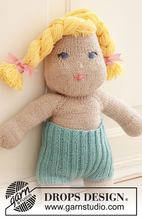 Cora / DROPS Children 35-12 - Knitted doll with short pants and tube socks. The doll is worked top down in stockinette stitch with 2 strands DROPS BabyMerino or 1 strand DROPS Big Merino, and DROPS Cotton Merino. Short pants and tube socks are worked in rib with 1 strand DROPS BabyMerino.