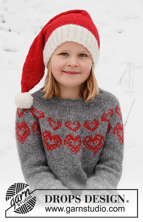 Merry Hearts / DROPS Children 41-3 - Dziecięcy sweter / świąteczny sweter i czapka / świąteczna czapka na drutach z włóczki DROPS Air. Sweter jest przerabiany od góry do dołu, z zaokrąglonym karczkiem i żakardem w serca. Czapka jest przerabiana na okrągło, od dołu do góry. Od 2 do 14 lat. Temat: Boże Narodzenie.