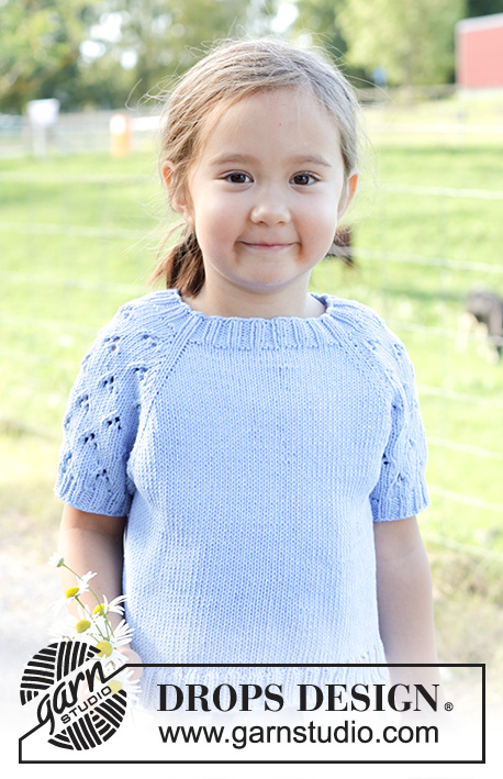 Daisy Fields Top / DROPS Children 48-3 - Knitted short-sleeved sweater/ top, for children in DROPS Cotton Light. The piece is worked top down with raglan and lace pattern on sleeves. Sizes 2 – 12 years.
