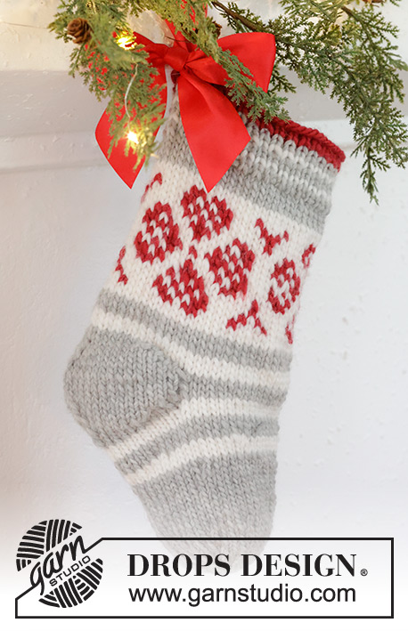 Christmas Flower Stocking / DROPS Extra 0-1573 - Knitted Christmas stockinette in DROPS Snow. The piece is worked top down, with stripes and Nordic pattern. Theme: Christmas.