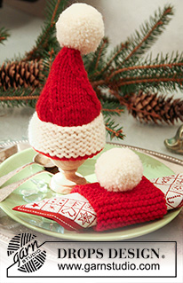 Santa's Breakfast / DROPS Extra 0-569 - Knitted egg warmer and serviette ring in DROPS Alaska. Egg warmer is worked as a santa hat with pompoms. Theme: Christmas