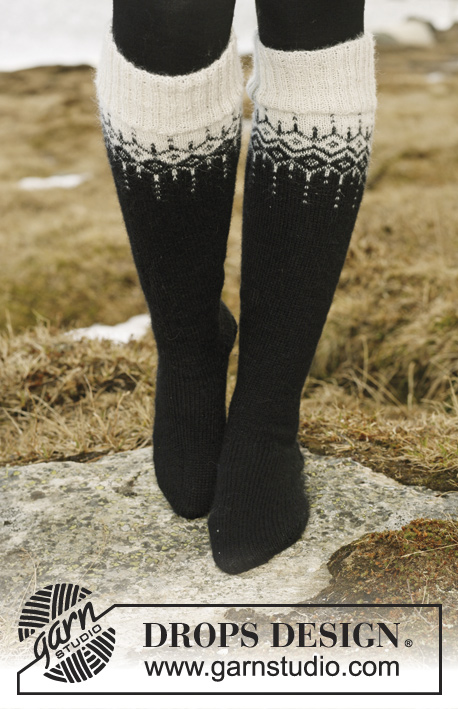 Winter Fantasy / DROPS 116-1 - DROPS Jacket in ”Alpaca” and ”Glitter” with 2-colour pattern in round yoke. Size S to XXXL. Long socks in ”Fabel” with the same pattern.
