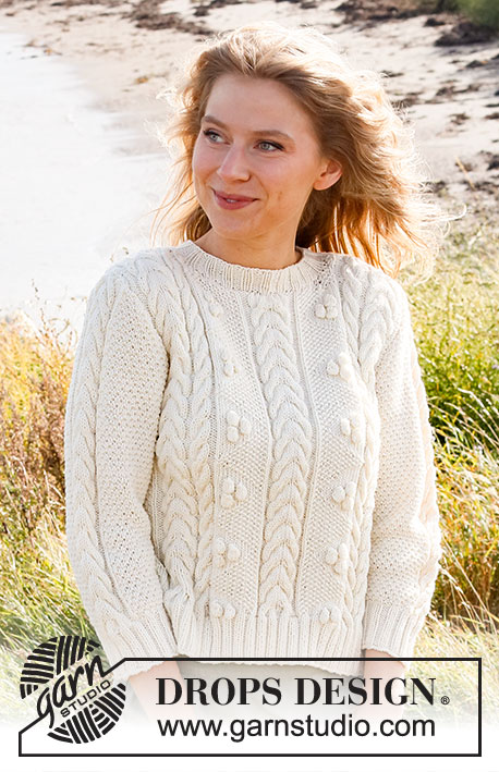 Bright Sand Shore / DROPS 222-35 - Knitted sweater in DROPS Merino Extra Fine. The piece is worked with cables, bobbles and ¾-length sleeves. Sizes S - XXXL.