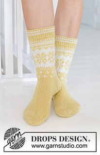 Easter Promenade Socks / DROPS 247-21 - Knitted socks in DROPS Nord. The piece is worked top down, with Nordic pattern and heel flap. Sizes 35 – 43. Theme: Easter.