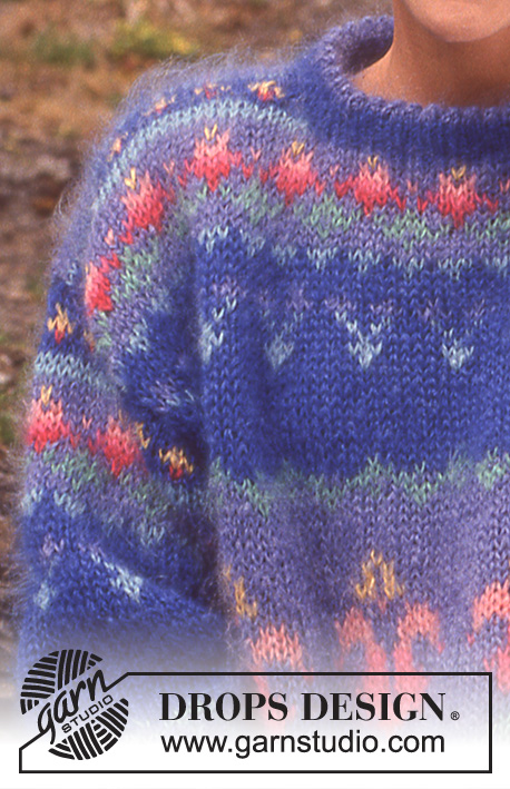 Garden Torches / DROPS 27-8 - Długi sweter na drutach, z włóczki DROPS Vienna, z żakardem w lilie. Od S do L.