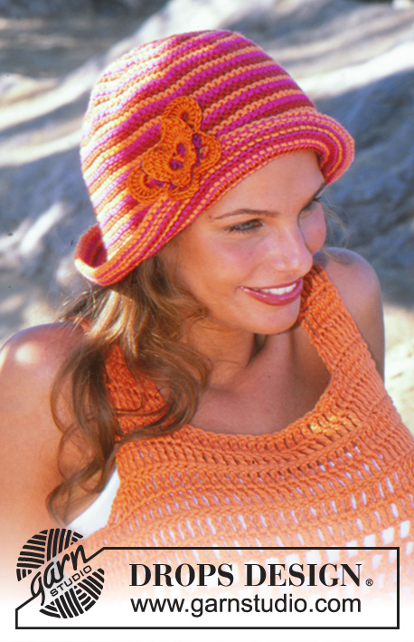 Just Peachy Hat / DROPS 82-34 - Knitted hat in DROPS Paris. With garter stitch and crocheted butterfly pin in DROPS Muskat. One-size.