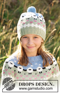 Lamb Dance Hat / DROPS Children 34-2 - Knitted hat for kids in DROPS Merino Extra Fine or DROPS Lima.
Piece is knitted bottom up with sheeps, color pattern, rib and pompom. Size 3-12 years